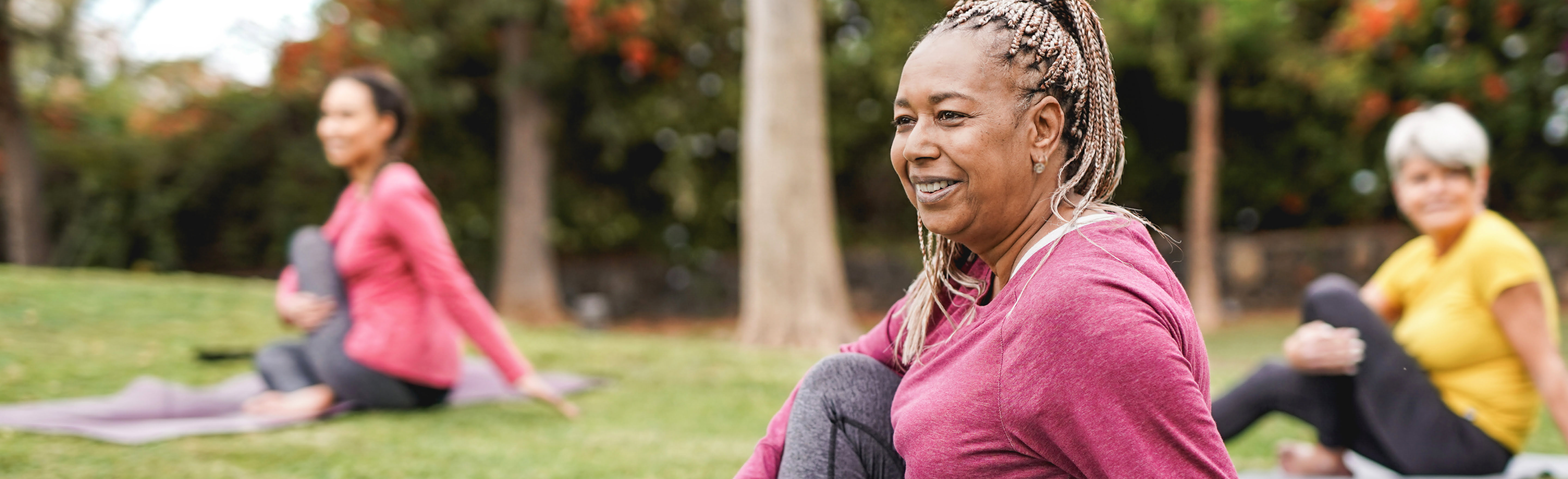 Older women doing yoga in a park