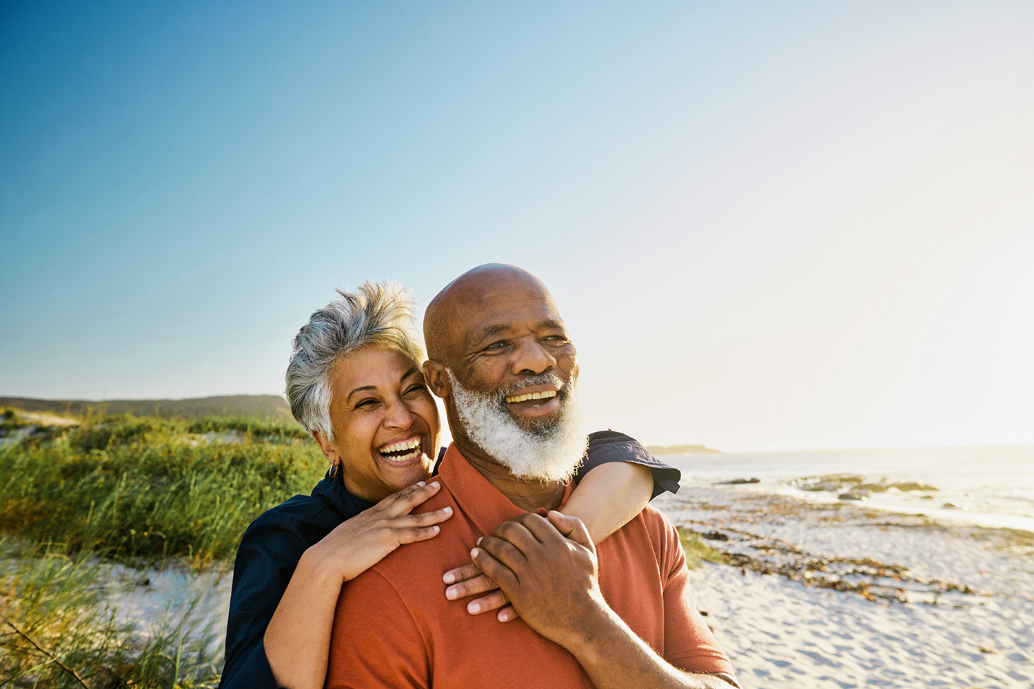 Couple embracing and smiling on beach shore