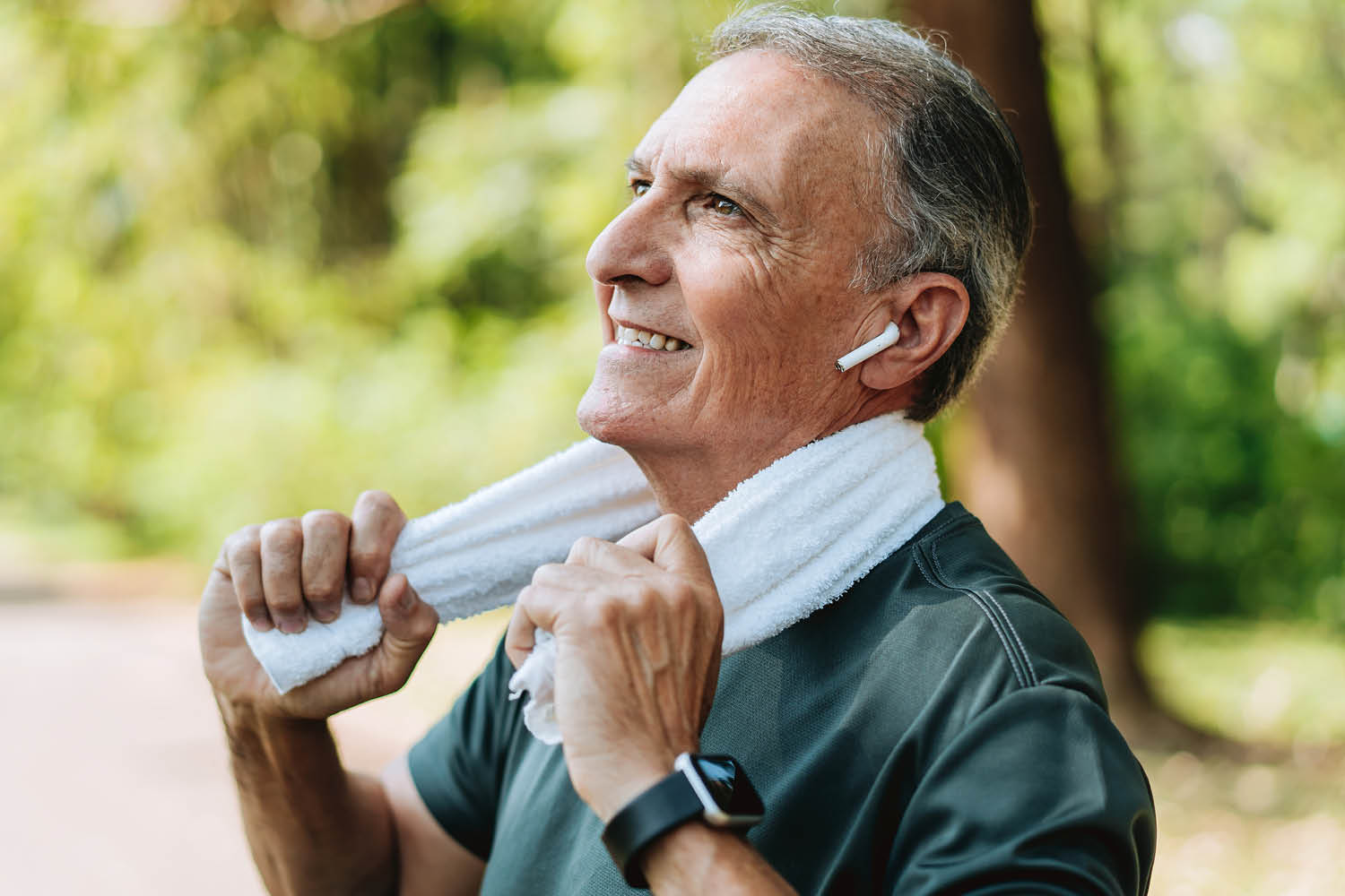 Man taking a rest and smiling after a run.