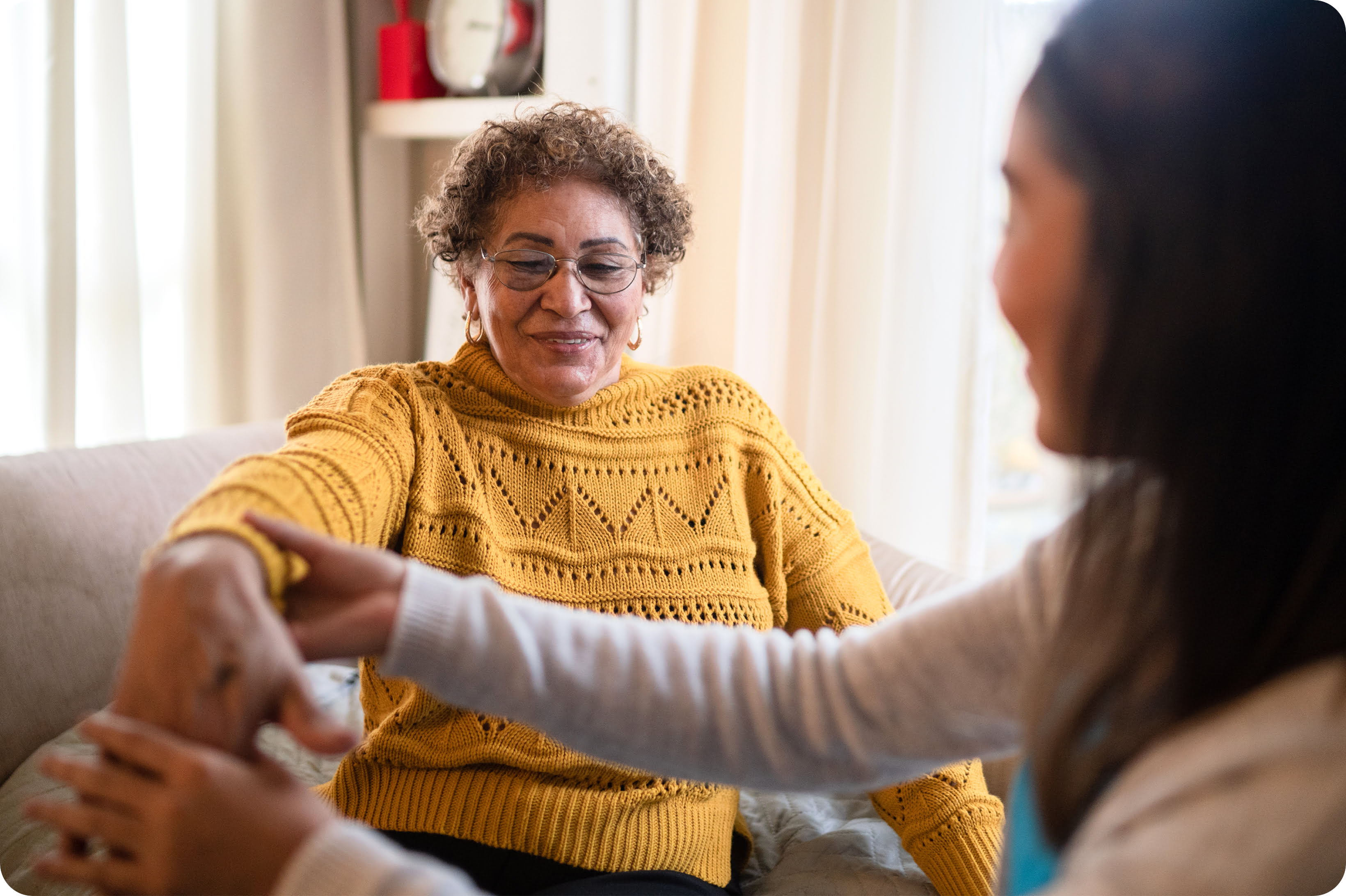 A care team member performing a health assessment in a patient’s home