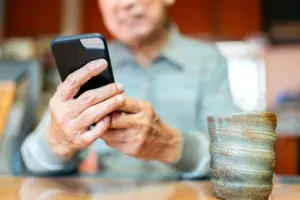 An older man looking at his cell phone