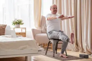 Senior exercising on chair