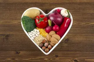 Bowl of fruits and grains in a heart shape