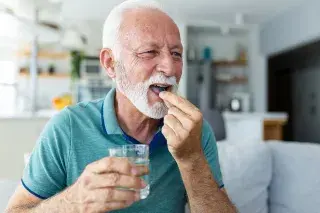 Senior taking necessary supplements