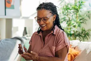 Senior checking their blood sugar level with a lancing pen