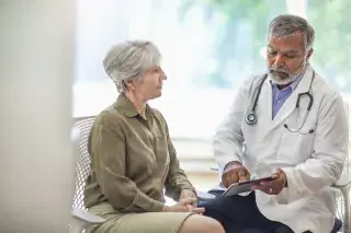 Patient visiting with doctor reviewing results on tablet
