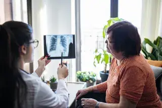 Doctor and senior patient looking at a chest X-ray