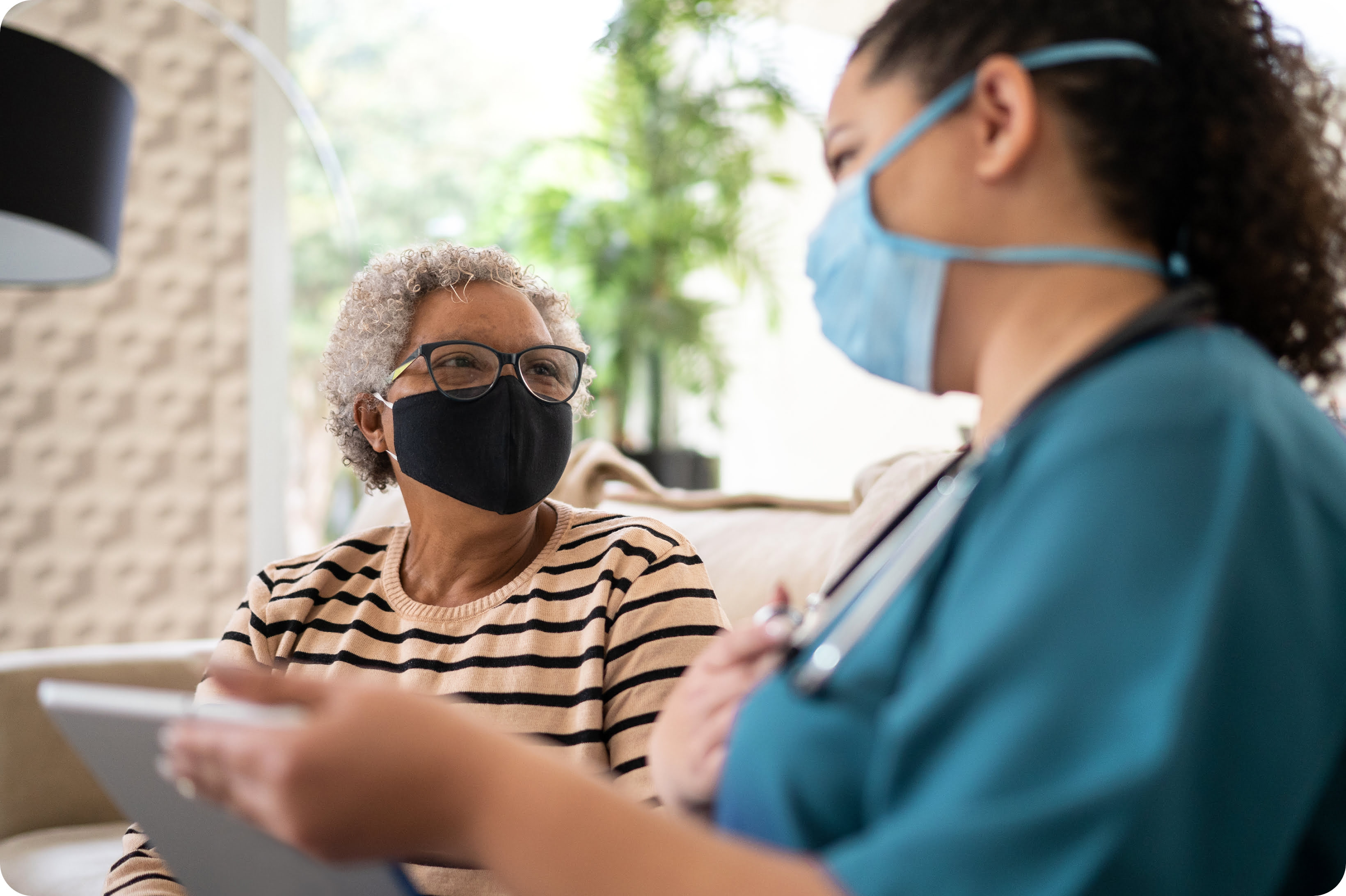 A care team member showing a patient something on a tablet